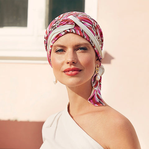This is the Beatrice Pink Print Turban from the Christine Headwear Collection